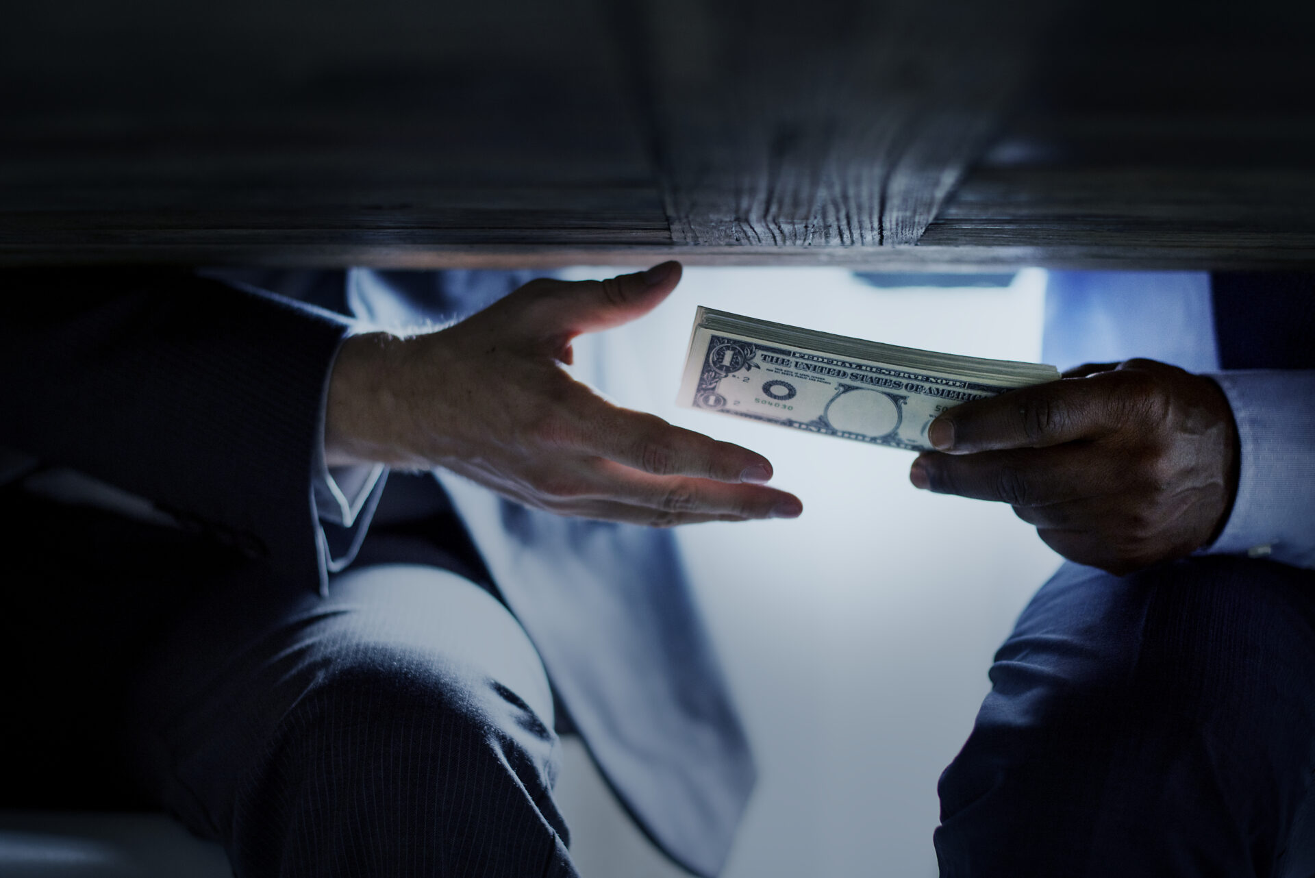 Two hands exchanging money